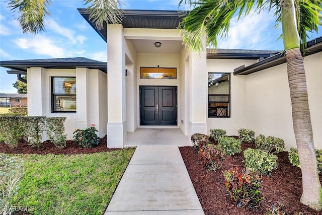 entrance to property with stucco siding