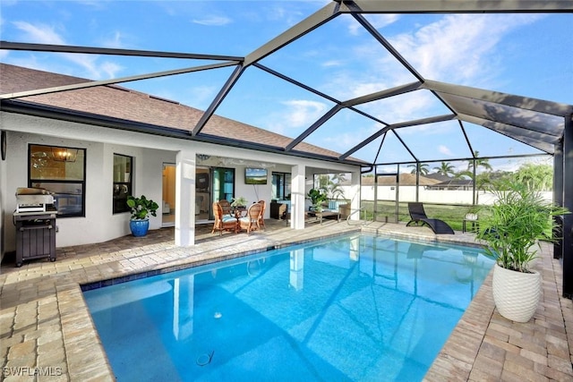 view of swimming pool featuring area for grilling, a fenced in pool, and a patio