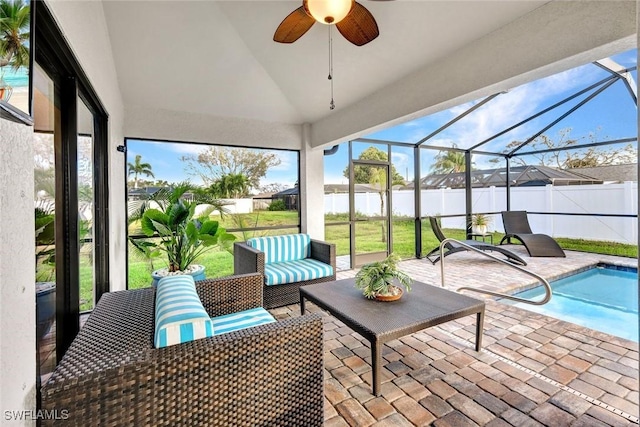 sunroom / solarium with a ceiling fan and vaulted ceiling