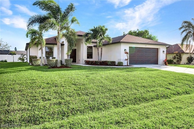 view of front of property with a garage, driveway, a front yard, and stucco siding