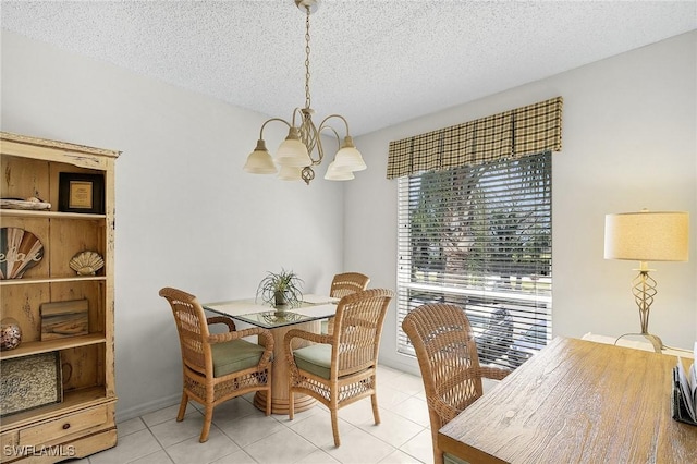 dining room featuring a chandelier, light tile patterned flooring, and a textured ceiling