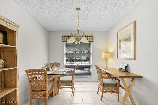 dining space featuring light tile patterned flooring, a textured ceiling, and an inviting chandelier