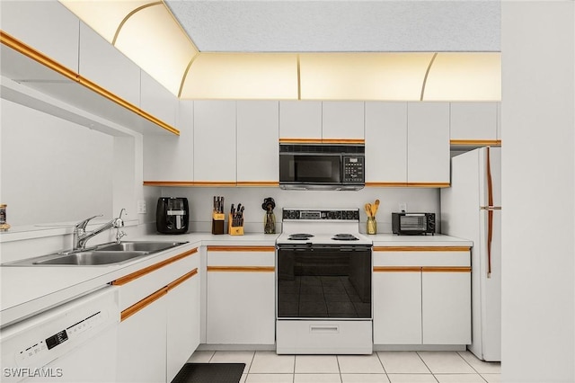 kitchen featuring white appliances, light countertops, a sink, and light tile patterned floors