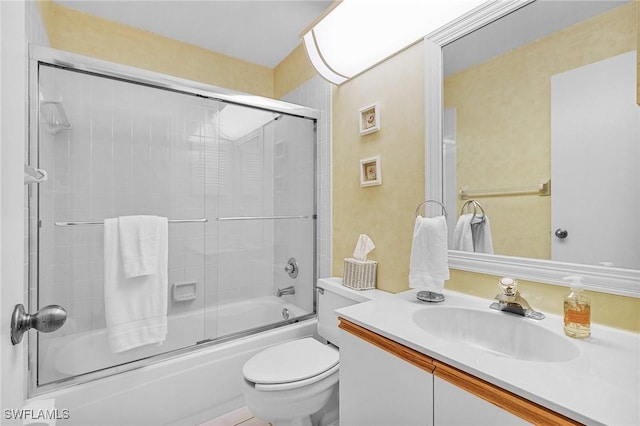 full bath featuring toilet, bath / shower combo with glass door, and vanity