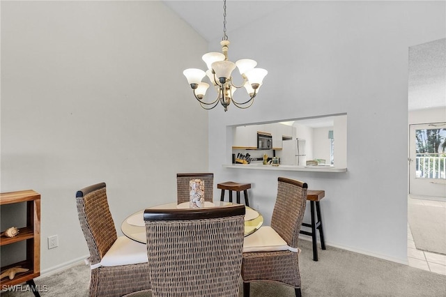 dining space with light carpet, high vaulted ceiling, baseboards, and a notable chandelier