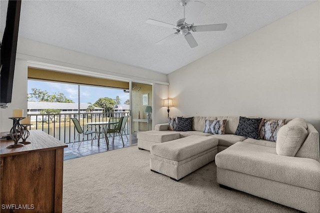 carpeted living room with a ceiling fan, vaulted ceiling, and a textured ceiling