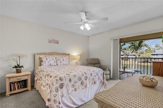 bedroom featuring access to outside, a textured ceiling, ceiling fan, and carpet flooring