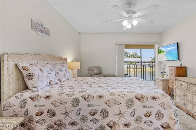 bedroom featuring access to exterior, ceiling fan, and a textured ceiling