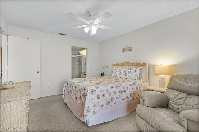 bedroom with light carpet, ceiling fan, visible vents, and a textured ceiling