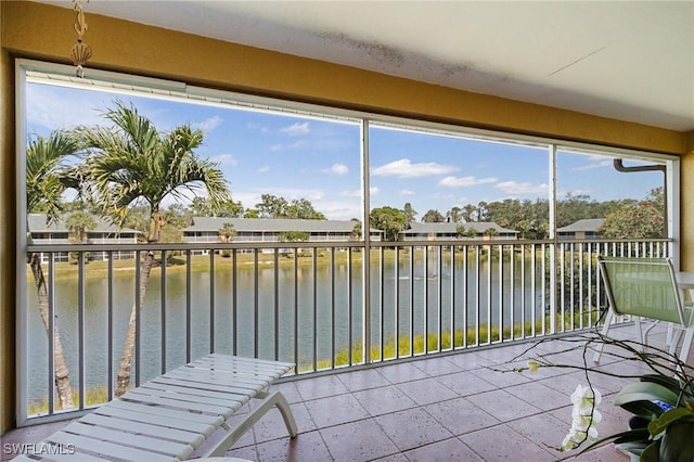 unfurnished sunroom with a water view and plenty of natural light