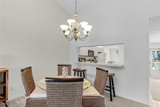 dining room featuring light carpet, baseboards, lofted ceiling, and a chandelier