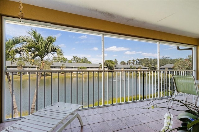 unfurnished sunroom featuring a water view and a wealth of natural light