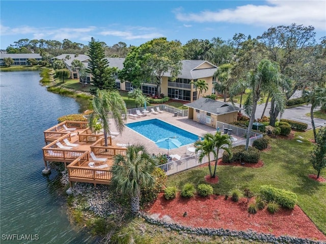 pool featuring a patio area, a fenced backyard, a lawn, and a deck with water view