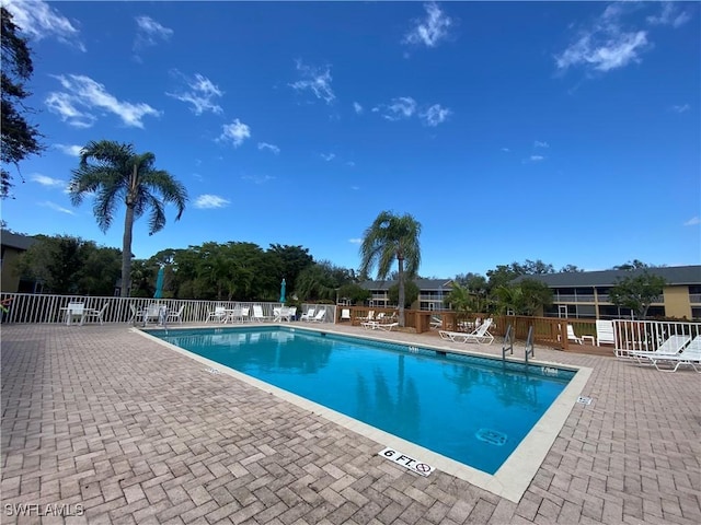 community pool featuring a patio area and fence