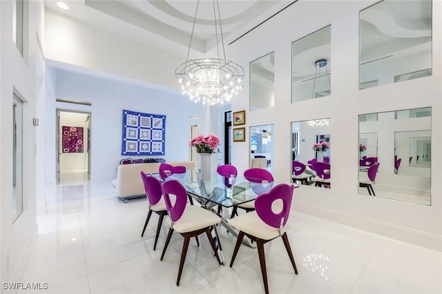 tiled dining space with a towering ceiling and a chandelier