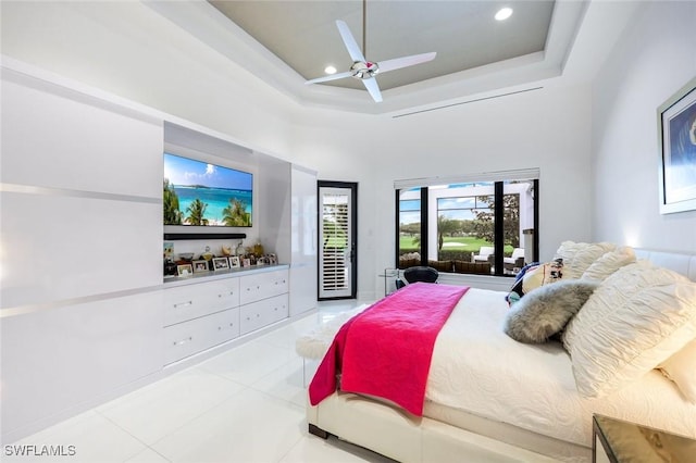 bedroom with a ceiling fan, recessed lighting, a towering ceiling, a raised ceiling, and access to outside