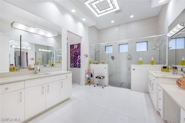 full bath featuring a sink, two vanities, and a shower stall