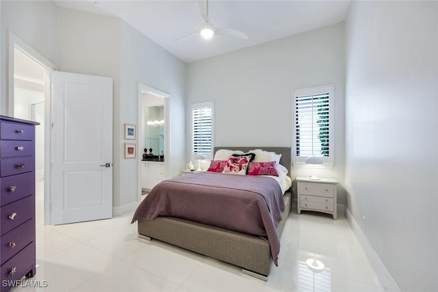 bedroom with light tile patterned floors, multiple windows, connected bathroom, and baseboards