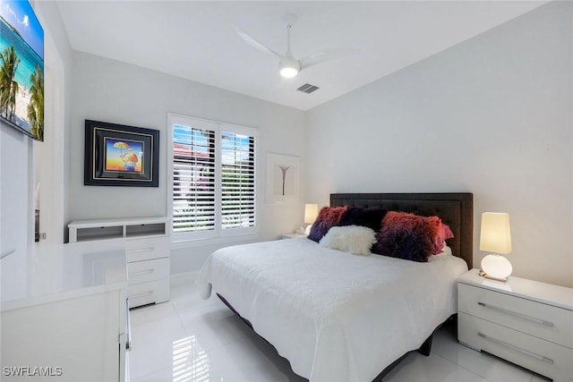 bedroom with visible vents, light tile patterned flooring, and a ceiling fan