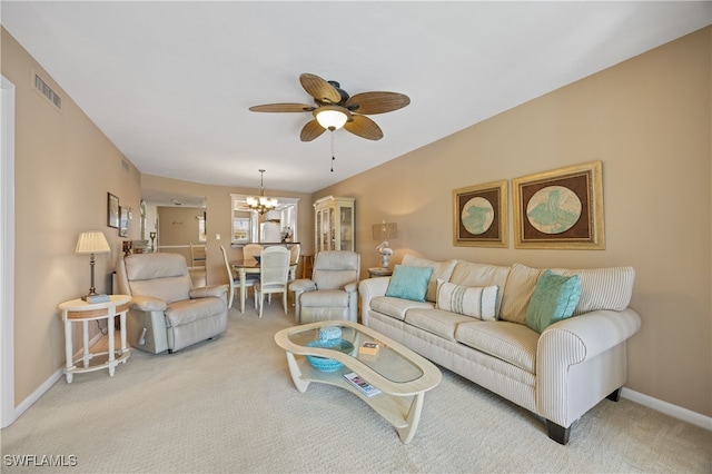 living area featuring light colored carpet, visible vents, baseboards, and ceiling fan with notable chandelier