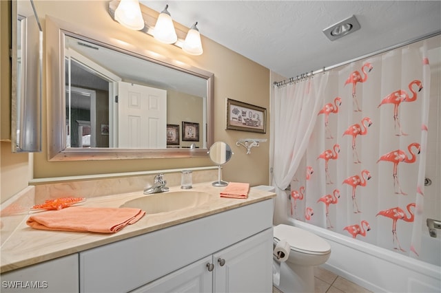 full bath featuring a textured ceiling, toilet, vanity, tile patterned floors, and shower / bath combo with shower curtain