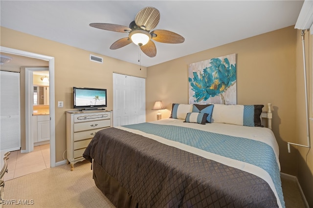 bedroom featuring light carpet, visible vents, ceiling fan, a closet, and light tile patterned flooring