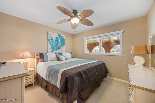 bedroom featuring ceiling fan, baseboards, and light colored carpet