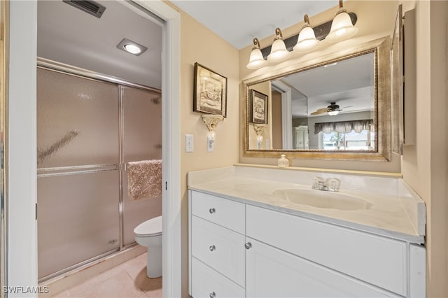 bathroom with visible vents, toilet, a stall shower, vanity, and tile patterned floors