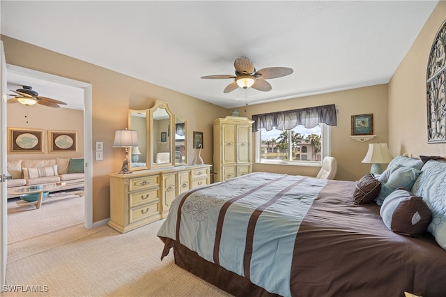 bedroom featuring light carpet, ceiling fan, and baseboards