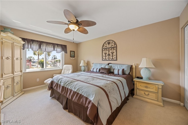 bedroom with light carpet, a ceiling fan, and baseboards