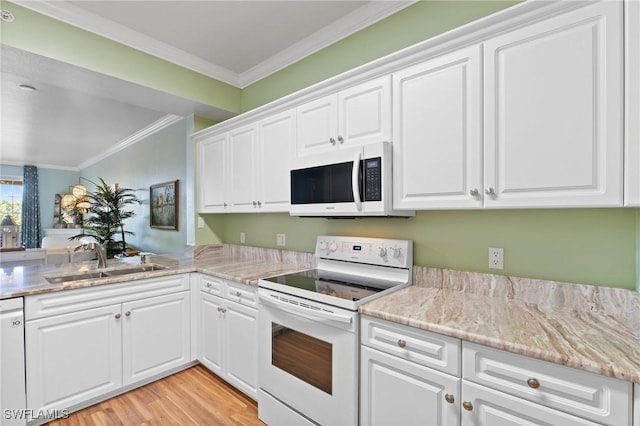 kitchen with white appliances, white cabinetry, ornamental molding, and a sink