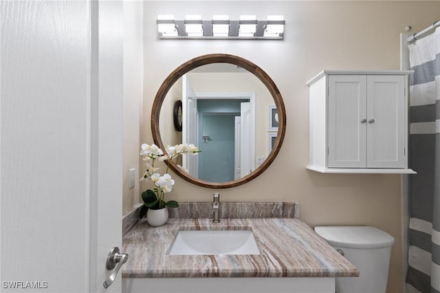 bathroom featuring vanity and toilet