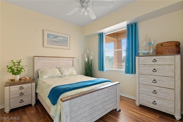 bedroom featuring dark wood-style floors, a ceiling fan, and baseboards