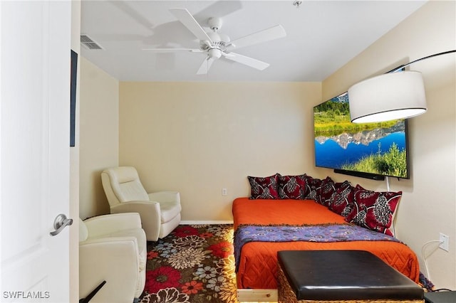 carpeted bedroom with visible vents and a ceiling fan