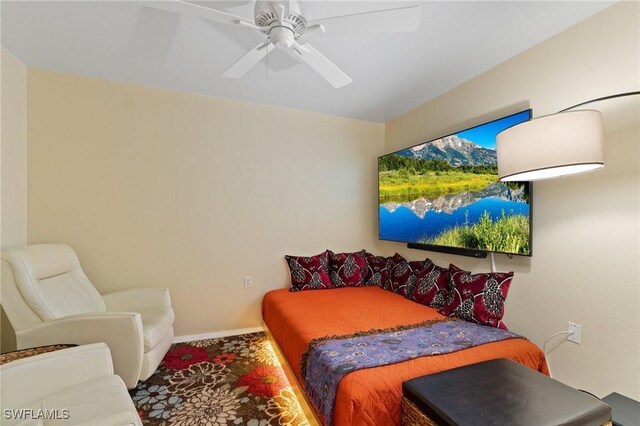 bedroom featuring a ceiling fan and baseboards