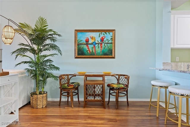 dining room featuring baseboards and wood finished floors