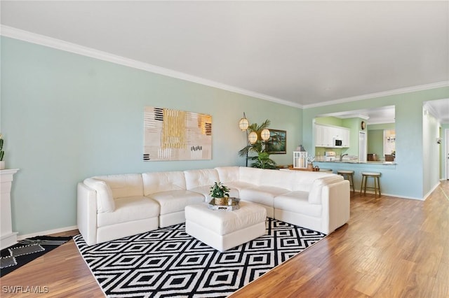 living area featuring crown molding and wood finished floors