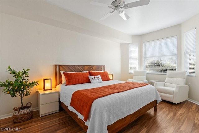 bedroom featuring ceiling fan, wood finished floors, and baseboards