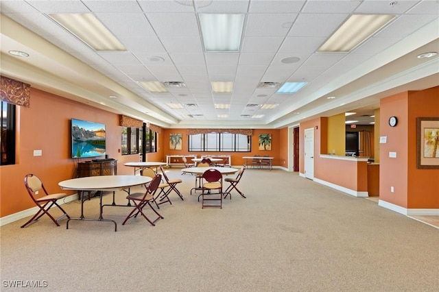 carpeted dining area featuring visible vents, a paneled ceiling, and baseboards