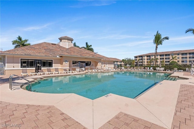 community pool with a patio area