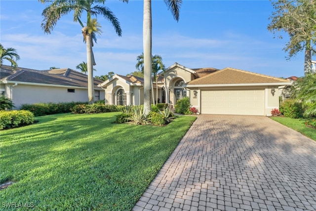 view of front of home featuring a garage, decorative driveway, a front yard, and stucco siding