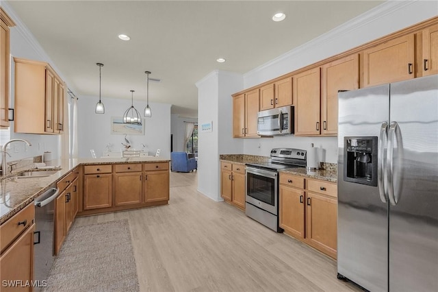 kitchen with appliances with stainless steel finishes, ornamental molding, a sink, dark stone counters, and a peninsula