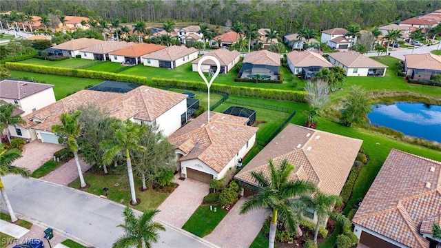 birds eye view of property with a water view and a residential view