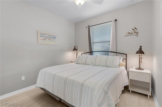 bedroom with a ceiling fan, baseboards, and wood finished floors