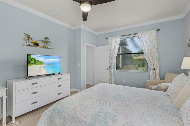 bedroom with a ceiling fan, baseboards, ornamental molding, and wood finished floors