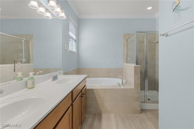 bathroom with ornamental molding, a stall shower, a sink, and a bath