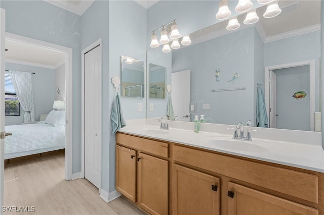 ensuite bathroom featuring ensuite bathroom, ornamental molding, and a sink