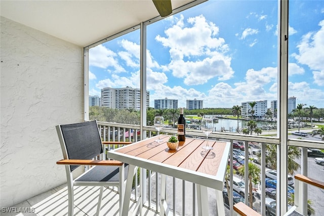 balcony featuring a view of city and a water view