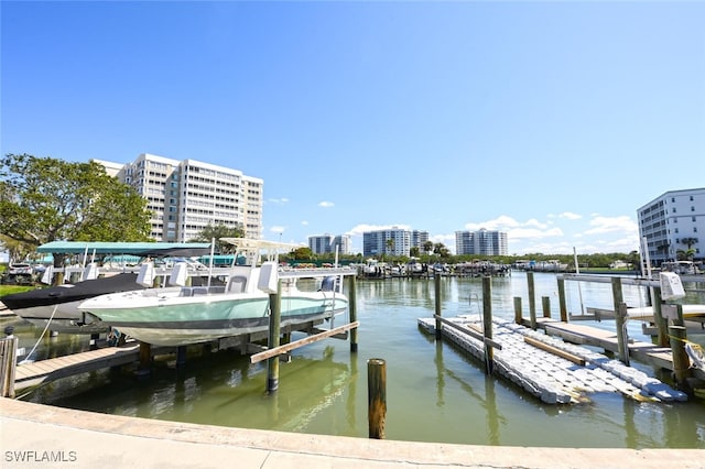 dock area featuring a view of city, a water view, and boat lift