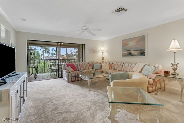 carpeted living room featuring visible vents, a ceiling fan, and ornamental molding